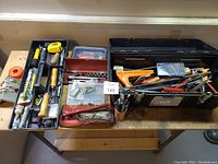Overview of the hand tools laid out with toolbox and cases showing the variety and condition