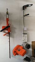 Black & Decker corded lawn edger and hedge trimmer hung on a wall, showing overall appearance.