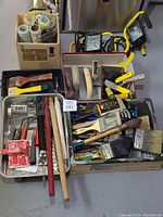 Wide view showing all painting tools, trowels, and worklights in boxes and trays