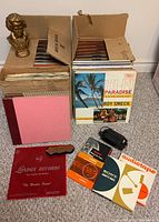 Two cardboard boxes packed with 78-speed records, some LP records, a bust of Beethoven, a red album, velvet record cleaner and box with records