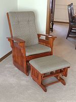 Front angle of the Shaker-style glide rocker with matching footstool in front showing upholstery and wood detail.