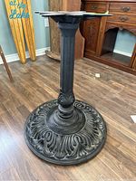 Full view of cast iron table base showing base and column