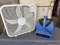Large white square box fan with circular grille.