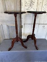 Full view of both wooden plant stands showing their shape and finish