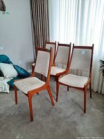 Three chairs arranged at angle showing frame shape and upholstery color