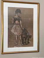 Framed print artwork of a girl with a dog, showing overall condition and framing