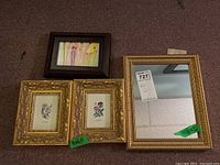 All three framed prints and the gold-framed mirror shown together on a carpeted floor.