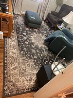Full view of rectangular rug under furniture in living space