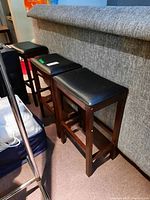 Three matching bar stools arranged side by side showing overall condition and matching design.