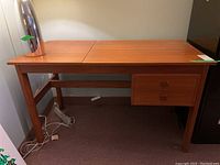 Front and top view showing full desk with hinged top closed and drawer configuration