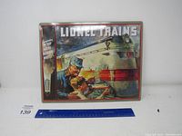 Full view of Lionel Trains vintage metal sign with ruler to show size