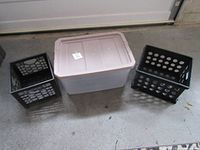 Three plastic storage containers: one large rectangular bin with lid and two smaller black crates with round holes