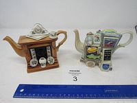 Both teapots side by side with ruler for size reference