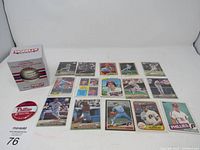 Overview of all items in the lot including baseball cards, a collectible baseball in box, and Phillies button