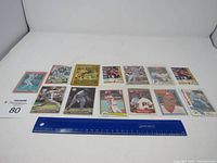 Full display of 12 assorted Philadelphia sports trading cards on white background with ruler for scale.