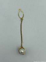 Front view of 18Kt gold tie pin with a pearl and attached chain and clasp