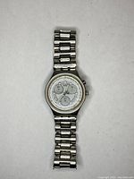 Full view of Swatch chronograph silver metal band watch on white background showing the dial and bracelet.