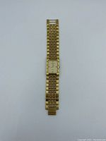 Full view of Wittnauer rectangular gold-tone watch with metal link bracelet on white background.