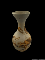 Front view of the Nemadji pottery vase showing the marbled brown and cream pattern, narrow neck, and flared rim.