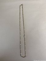 Full length view of the vintage silver necklace on a white background.