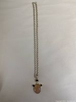 Full view of silver chain necklace with the multi-gemstone pendant arranged centrally.