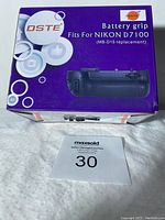DSTE Battery Grip box front showing branding and compatibility for Nikon D7100 MB-D15 replacement.