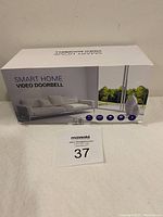 Front of the box showing product name, icon features and living room image.