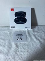 Front of box showing the image of black wireless earbuds in charging case and branding.
