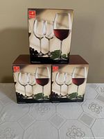 Three unopened boxes each labeled Bormioli Rocco Nebbiolo with red wine glass illustration showing the product packaging