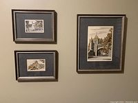 Framed watercolor paintings and Blue Heron print hung on a wall, showing three Quebec City watercolors and the print by Art Lamay.