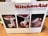Closed original box of KitchenAid meat grinder attachment showing product images and branding.