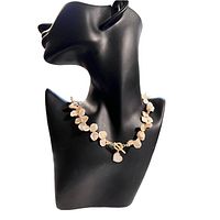 Full view of pink champagne Keshi pearl necklace displayed on black bust showing pearls and gold plated toggle clasp with heart-shaped mother of pearl charm.