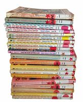 Stack of 20 Baby-Sitters Club books showing spines with titles and series numbering.