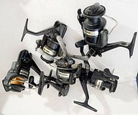 Five Daiwa Long Cast X spinning reels arranged together showing general condition and quantity.