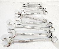 Photo showing all eight vintage Kmart combination wrenches with chrome finish, arranged on a white surface.