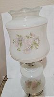 Full lamp showing shape, color, and floral pattern on shade and base
