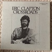 Front cover of the Eric Clapton Crossroads box set, showing black and white photo of Eric Clapton playing guitar with text 'ERIC CLAPTON CROSSROADS'.