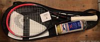 Head MX Elite Lady tennis racquet inside a black and white carrying case with two Slazenger XL tennis balls in a pressurized can next to the racquet.