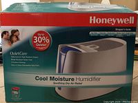 Original box showing product branding and features, including QuietCare technology and quiet operation.