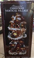 Box front with product image and title: Illuminated Christmas Vertical Village