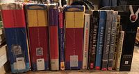 Spines of 9 books including five Harry Potter books and four Artemis Fowl books showing their titles and condition