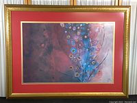 Frontal view of the abstract floral print in gold frame with red double mat.