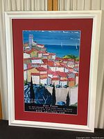 View of the full framed poster showing the colorful artwork, red mat, white frame, and overall dimensions.