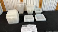 Photo of all containers grouped by size showing varying stack height and lid types, with instruction sheet in front