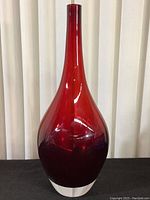 Front view of the tall ruby red bud vase showing its shape, color, and neck length.