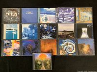 Full view of 16 CDs by The Moody Blues showing various album covers in jewel cases.