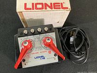 Front view of vintage Lionel Type 4090 transformer showing control panel with red knobs, voltage settings, cords and original box.