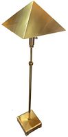 Full side view of vintage brass floor lamp with pyramid-shaped shade and square base