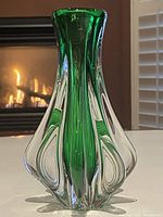 Perspective front view showing green inner glass with clear outer layering and flared shaped body