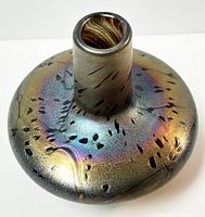 Top angle view showcasing the iridescent, multicolored surface of the blown glass vase with black abstract markings.